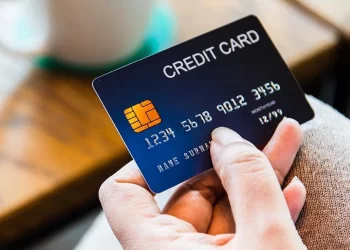 Person holding Credit Card | FintechZoom