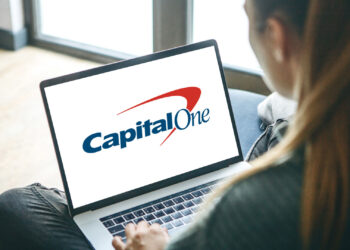 Person using laptop to enter on Capital One Website | FintechZoom