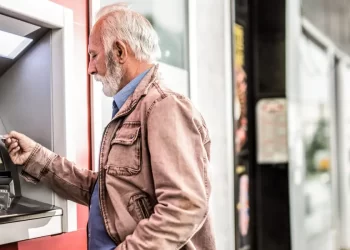 Person on atm in state of california | FintechZoom