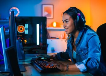 Person on computer desk | FintechZoom