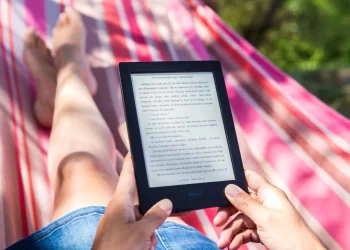 Person reading on Tablet | FintechZoom