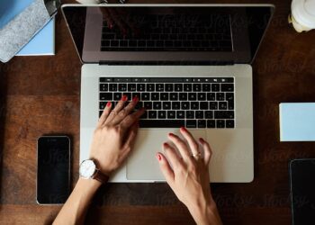 Woman using laptop | FintechZoom