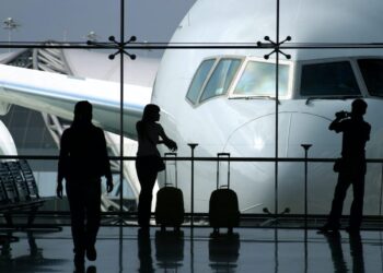 Person waiting for an airplane | FintechZoom