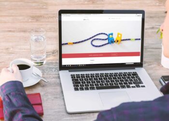 Person looking at open laptop | FintechZoom