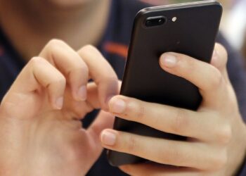 Person using phone | FintechZoom
