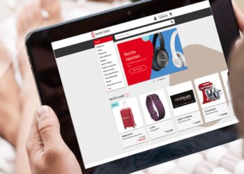 Person using tablet to see Qantas Shopping Online | FintechZoom
