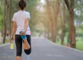 Woman exercising in the park | FintechZoom