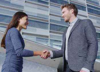 Businessman shaking hands | FintechZoom