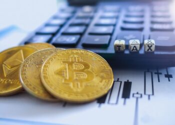 Crypto coins over a calculator, a plan and tax fonts | FintechZoom