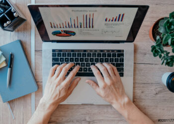 Top view man using laptop | FintechZoom