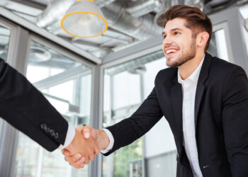 Businessman handshake on meeting | FintechZoom