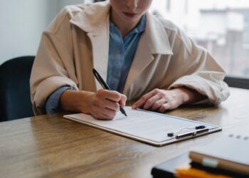 Woman filling tax | FintechZoom