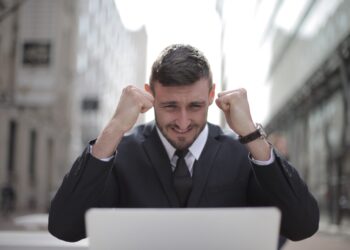 Man in Black Suit Achieved an Accomplishment | FintechZoom