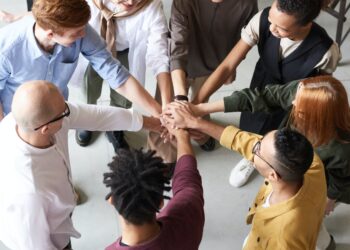 People Holding Each Other's Hands | FintechZoom