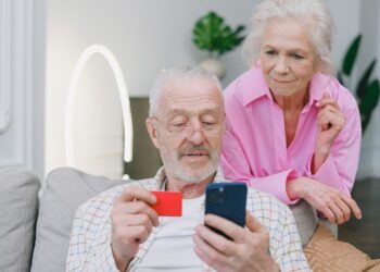 An Elderly Couple Making an Online Transaction | FintechZoom
