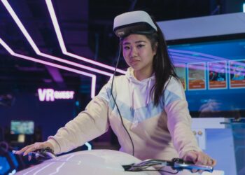 A Woman Playing Virtual Reality Glasses | FintechZoom