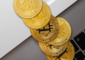 Golden bitcoins over mac keyword | FintechZoom