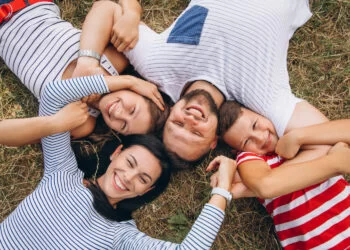 Parents with their children walking in forest | FintechZoom