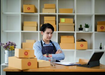 SME owner on laptop | FintechZoom