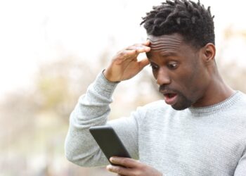 Man on Mobile | FintechZoom