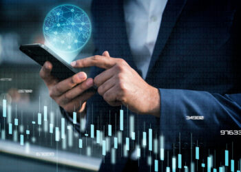 Close up hand holding smartphone | FintechZoom