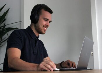 A business man on Laptop | FintechZoom