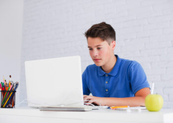 Young boy on laptop | FintechZoom
