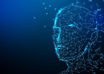 A digital wireframe representing a human head and upper torso, made up of connected blue triangular facets, glows against a dark blue background. Small blue lights and particles are scattered around the wireframe, giving a futuristic and abstract feel akin to the best AI tools' visualizations. | FintechZoom