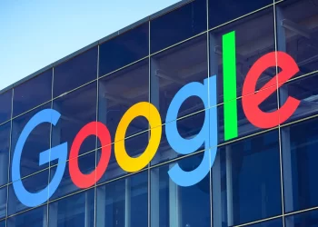The image shows a large Google logo on the exterior of a glass building, spotlighting Alphabet's vibrant presence. The logo features "Google" in colorful letters: blue "G", red "o", yellow "o", blue "g", green "l", and red “e," reflecting its dynamic brand just like Alphabet stock. | FintechZoom