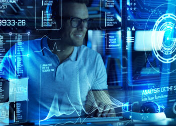 A man wearing glasses is working at a computer with multiple holographic data screens around him. The screens display various charts, graphs, and data points related to the business's revenue potential. He appears focused and engaged in analyzing the information. The setting is futuristic and high-tech. | FintechZoom