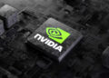 A close-up of NVIDIA's green and black logo on a computer chip, placed on a dark circuit board. The image emphasizes the intricate details and components of modern computer hardware technology, reflecting why NVIDIA might be among the best stocks to buy in 2024. | FintechZoom