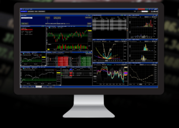 A computer monitor displays the best share trading platform with multiple windows showing stock charts, graphs, and various market data. The interface is predominantly dark with green, red, and blue elements indicating different metrics and performances. | FintechZoom