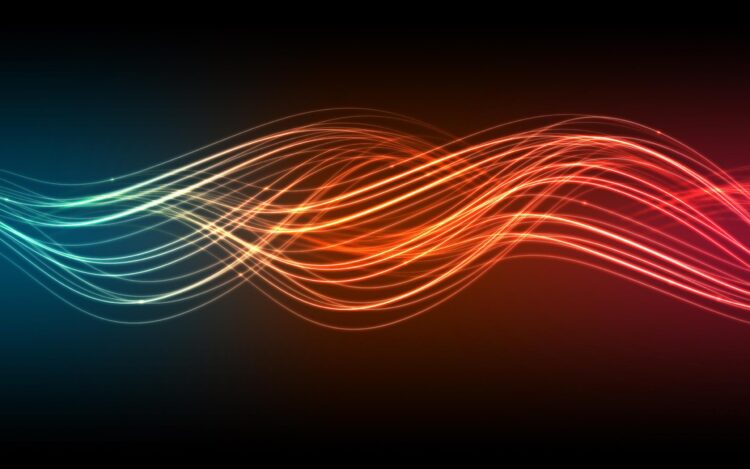 A vibrant, abstract image featured on FintechZoom showcases intertwined, glowing light waves in shades of blue, orange, and red against a dark background, creating a dynamic and energetic visual effect. | FintechZoom