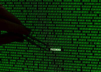 A hand holding tweezers is visible against a backdrop of green binary code (ones and zeros) on a black screen. The tweezers are extracting the word "PASSWORD" in white letters from the stream of code, highlighting the risk of data breaches. | FintechZoom