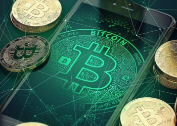 A smartphone displaying a glowing Bitcoin symbol surrounded by stacks of physical coins. The background features a network-themed graphic, emphasizing the digital and connected nature of cryptocurrency. | FintechZoom