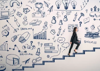 A businesswoman in a suit climbs a set of illustrated stairs, symbolizing career advancement. The background is filled with various hand-drawn business-related doodles, including charts, graphs, light bulbs, a target, and icons representing success, planning, and innovation. | FintechZoom