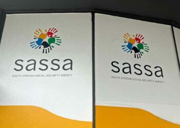 Posters with the logo and name of the South African Social Security Agency (SASSA) are displayed, highlighting important information about the Sassa Appeal process. The logo features five colorful handprints interlinked in a circle. | FintechZoom