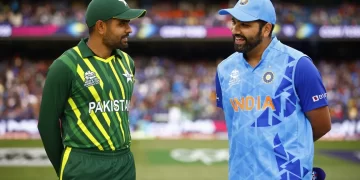 Two cricketers stand on a field, engaged in conversation. One wears a green and yellow Pakistan uniform, while the other is in a blue and orange India uniform. A crowd in the background suggests it's an exciting India vs Pakistan Asia Cup 2023 match setting. | FintechZoom