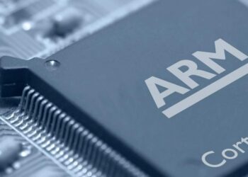 Close-up image of an ARM Cortex microprocessor chip on a circuit board. The chip is prominently labeled with the ARM logo, indicative of Arm stock's dominance in tech, and the surrounding area shows parts of the circuit and other electronic components. The image emphasizes intricate design and technology. | FintechZoom