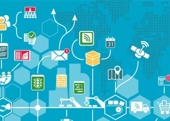 Illustration depicting various interconnected technology and communication icons overlaid on a blue background with a faint world map. Icons include email notifications, email marketing software, calendar, GPS, satellite, factory equipment, shipping truck, and various data symbols. | FintechZoom