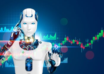 A futuristic robot with a sleek white and blue design stands in front of a digital interface displaying stock market graphs and charts. Utilizing advanced AI tools, the robot touches its temple with one hand, its glowing chest revealing visible inner circuitry. | FintechZoom