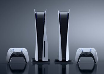 Two PlayStation 5 consoles, one with a disc drive (left) and one digital edition (right), stand upright. Each console is accompanied by a white DualSense controller placed in front of it, ready to immerse you in the best PS5 games. The background is a sleek, gradient gray. | FintechZoom