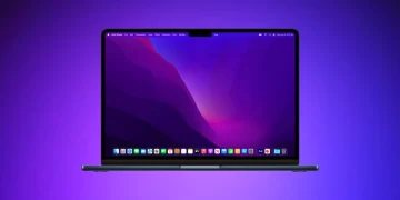 A sleek laptop with a vibrant screen displaying a colorful, abstract wallpaper in shades of purple and red. The desktop shows various icons and an application toolbar at the bottom, one of which is designed to remove malware. The background has a gradient from blue to purple. | FintechZoom