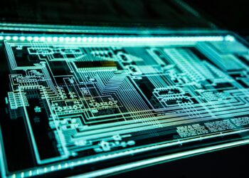 A close-up of an illuminated circuit board with intricate light blue circuitry against a dark background. Complex patterns and connections are visible, creating a futuristic and high-tech appearance, highlighting the important role of cybersecurity in safeguarding these advanced systems. | FintechZoom