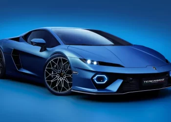 Lamborghini Temerario car with a blue exterior is showcased against a gradient blue background. The car features an aerodynamic design, angular headlights, and stylish alloy wheels. A license plate on the front reads "TEMERRARIQ. | FintechZoom