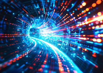 A dynamic tunnel of glowing blue and orange lights creates a futuristic, high-tech effect reminiscent of the speediest VPNs. The lights blur into streaks, suggesting motion and speed, as they twist and curve around the tunnel, evoking advanced digital technology or data flow. | FintechZoom