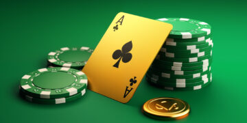 A green poker table with stacked green and white poker chips, an ace of clubs card leaning against the stacks, and a single gold coin featuring a spade symbol. The background is a smooth, gradient green. | FintechZoom