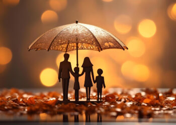 Silhouette of a family of four holding an umbrella, surrounded by autumn leaves. The background is softly blurred with warm, glowing bokeh lights, creating a cozy and protective atmosphere. | FintechZoom