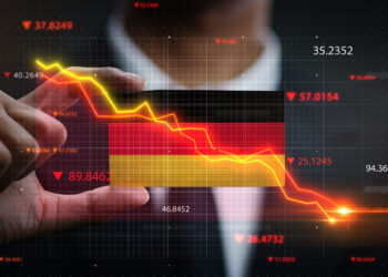 A person in a suit points at a graph displaying a downward trend in red and yellow, with the German flag in the background. Multiple numerical values are scattered around, hinting at DAX 40 fluctuations reported by FintechZoom.com. | FintechZoom