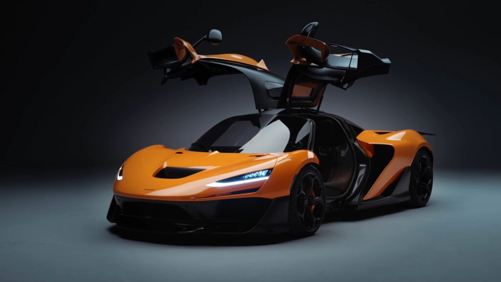 A sleek, orange McLaren W1 sports car with its butterfly doors open against a dark background. The car features futuristic headlights and a low, aerodynamic design, showcasing luxury and high performance. | FintechZoom